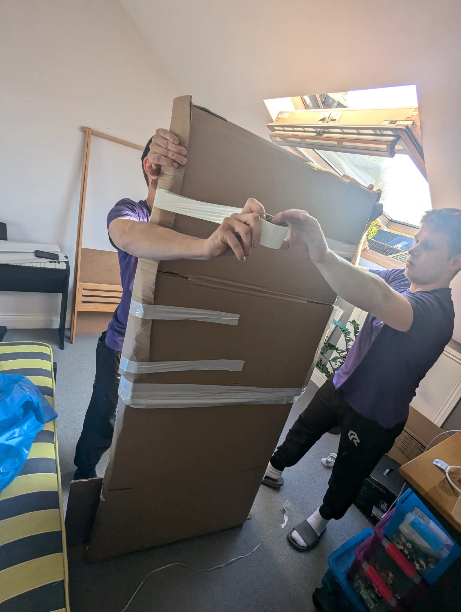 "Rad Removals team member carefully preparing a large mirror for safe transportation at a client's address