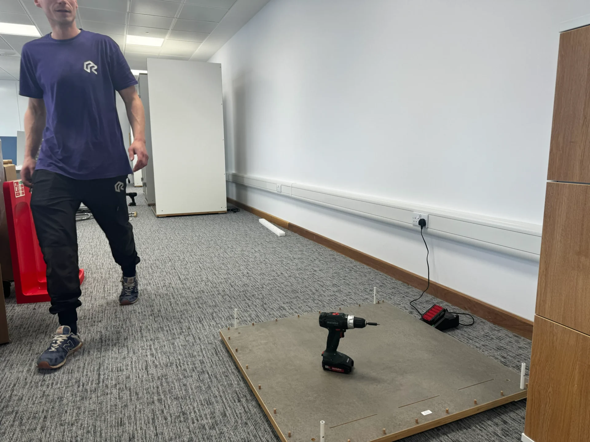 The RAD Removals and Storage team preparing for an office fit-out, showcasing tools and equipment in a professional London workspace.