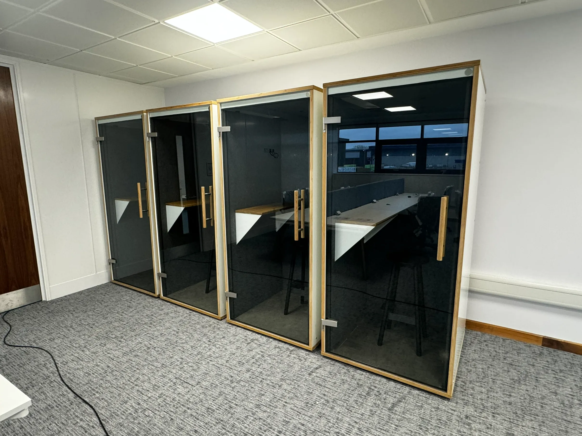 The RAD Removals and Storage team expertly installing modern office meeting booths in a London workspace