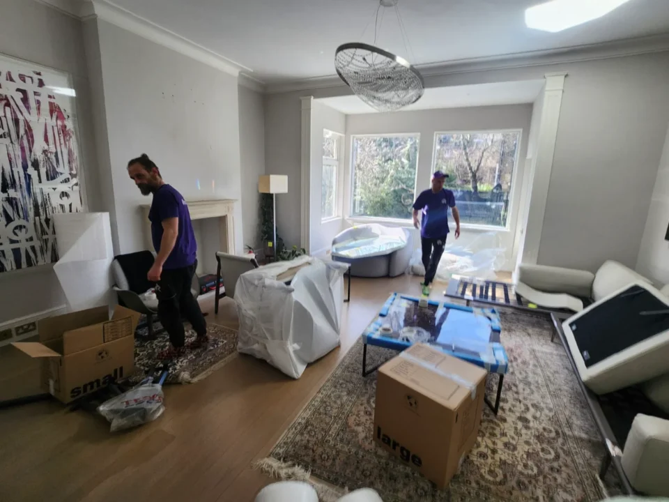 Rad’s team wrapping artwork and package artwork for storage in a West London living room, performing antique removal and antique furniture removal with precision.
