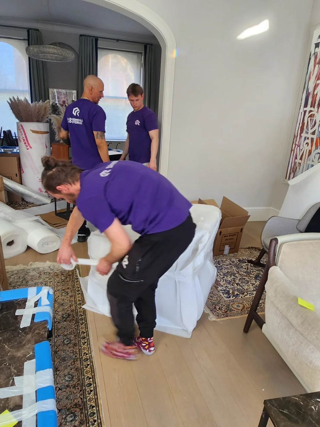 Rad team packing furniture for renovation storage and storage renovation in West London, showcasing renovation storage solutions before a project.
