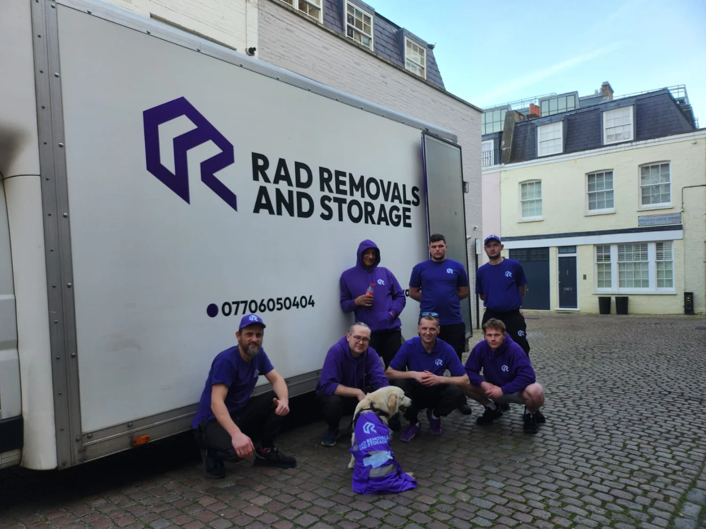 Rad team with golden retriever Toby in a high-vis vest next to a Rad van in West London, preparing for storage for refurbishment before a renovation.
