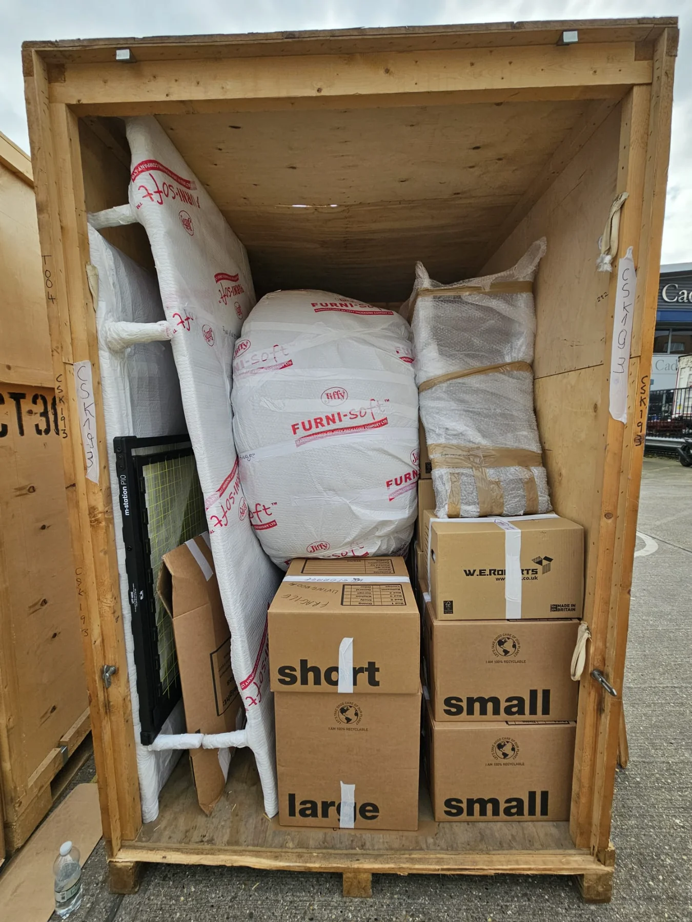 Neatly organized storage unit at Rad’s West London facility, showcasing freight-wrapped furniture and boxes for antique storage, vintage storage, and vintage record storage, balanced for safety